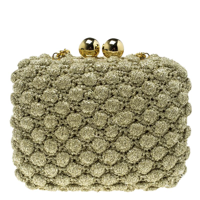 Dazzling in a shimmering gold hue, the Dolce & Gabbana clutch is crafted from fabric featuring a unique, striking pattern all over. It's interior is carefully lined with velvet to fit all your party essentials. Finished with a single chain-link