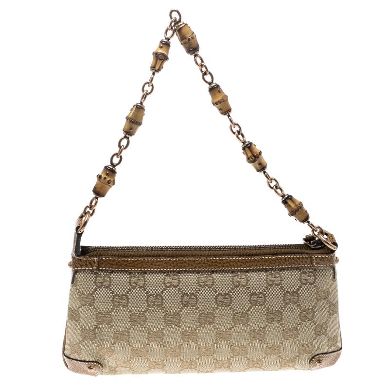 A perfect companion for your evening outings, this Gucci pochette is crafted from a beige GG canvas body and trimmed with brown leather. It is secured with a top zipper closure and is just aptly sized to hold your essentials. Complete with bamboo