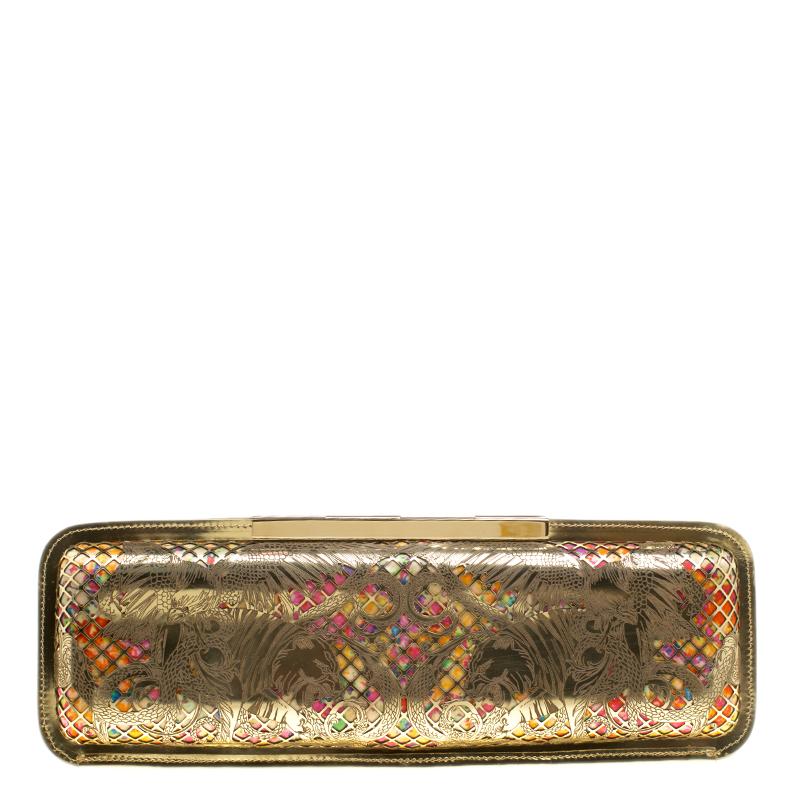 Have all eyes on you when you flaunt this stunner of a clutch by Roberto Cavalli. Crafted from gold-tone metal in laser cuts with colourful fabric inlay, this piece opens to reveal a leather interior with a zip pocket for your essentials. It is