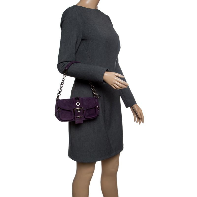Get yourself this good-looking suede bag for a posh look. Prada has exclusively made this delicate piece in a classy purple colour with a buckle flap and a single chain handle. Complete with a nylon inlay, the bag is stylish and