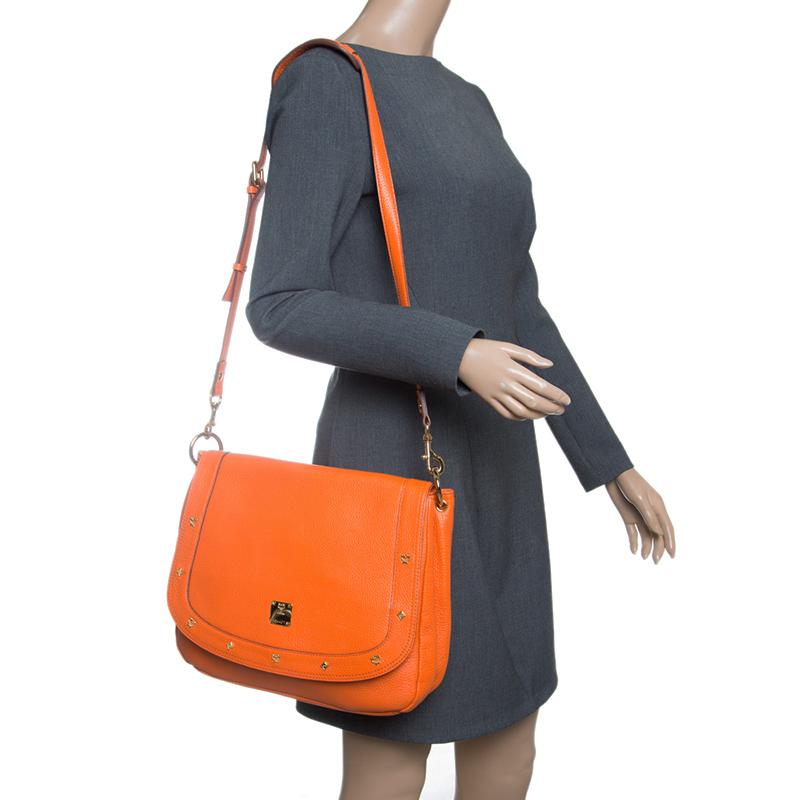 Pair your daily outfits with this orange bag from MCM. Made of leather, this attractive piece is a lovely creation to own. The fabric interior makes it perfect to stow away your essentials while the top handle and the shoulder strap are for you to