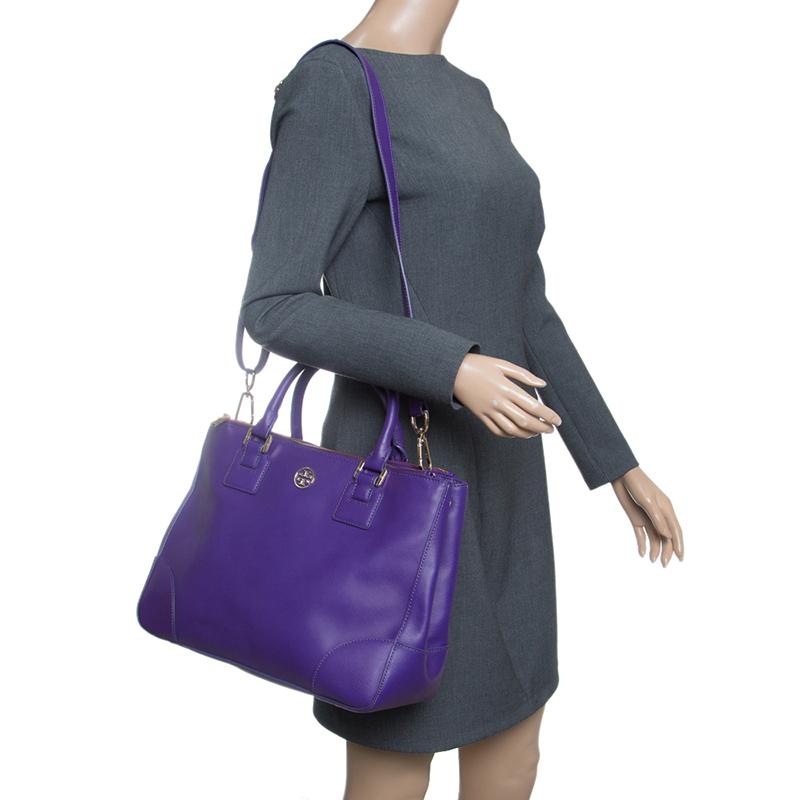 This gorgeous Robinson tote is from Tory Burch. It carries a purple exterior made of leather and it has been equipped with two top handles, a shoulder strap, and a spacious fabric interior. The tote is ideal for everyday use.





Includes: Original