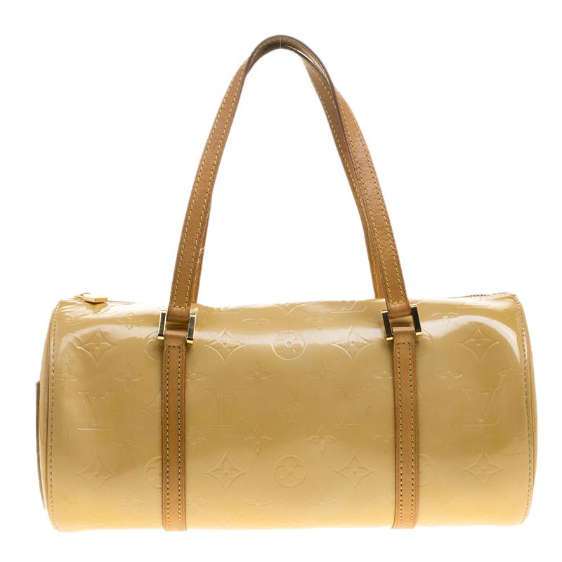 Another classic from the house of Louis Vuitton is this beautiful Bedford. The beige bag is made from the signature Monogram Vernis patent leather that was introduced in 1998, lending it a shiny and glossy effect. In shape, it resembles their famous