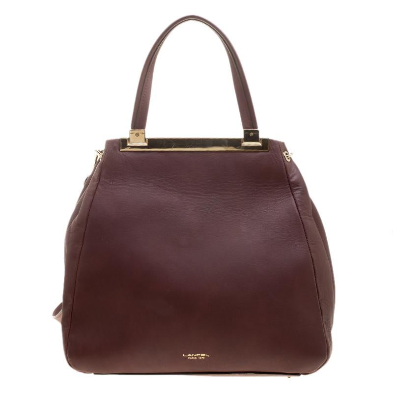 Carry this classy leather tote from Lancel and get ready to conquer the world. This one will surely meet all your expectations. The high-quality fabric lining on the inside gives shape and space for your things. The rare design of this burgundy