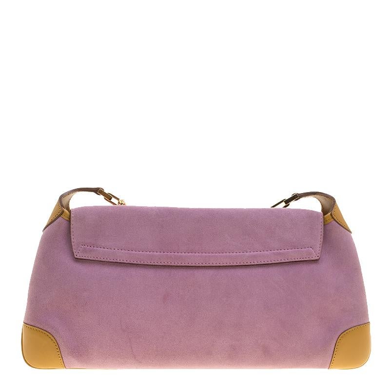 This beautifully crafted suede and leather shoulder bag is designed to complement your elegant nature. This wonderful purple bag exudes a classy aura. The flap has a tiger charm and the nylon lining makes it perfect enough to stow away your