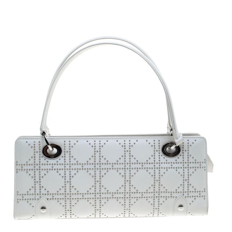 Fall in love instantly with this shoulder bag by Dior. Made from white leather, it is just about splendid as a style statement and for your essentials. The bag has studs lined in their Cannage pattern, a well-sized fabric interior and handles for