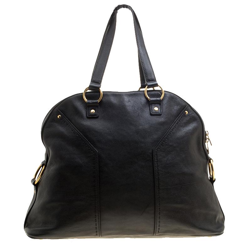 This Saint Laurent Muse tote is perfect for everyday use. Crafted from leather, this black tote has top handles attached to gold-tone rings and protective metal feet. The top zip closure opens to a roomy satin-lined interior with enough room to keep