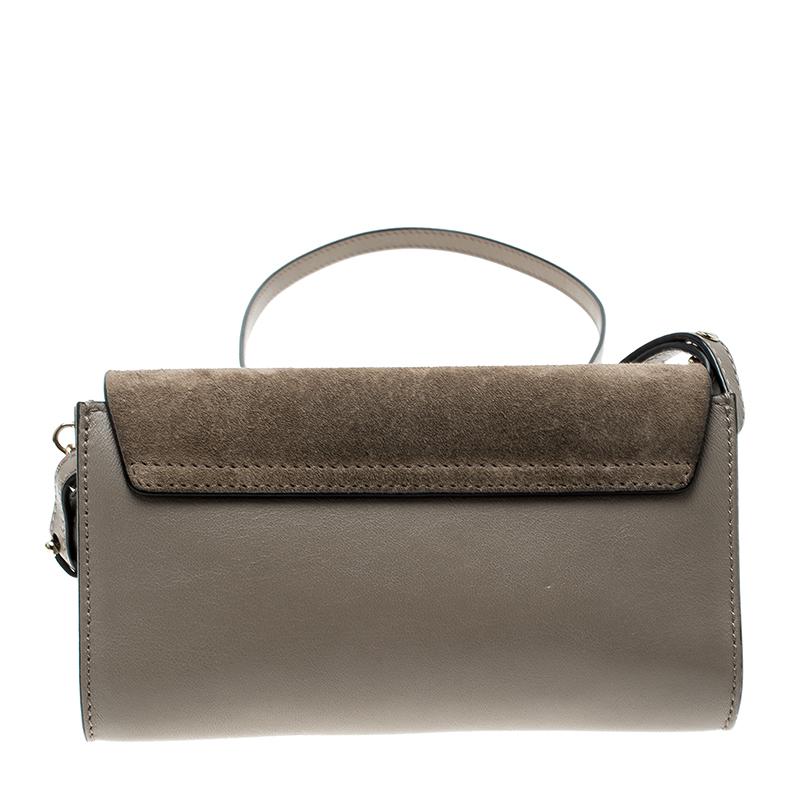Made beautifully, this Chloe mini Faye shoulder bag comes in an enchanting light taupe hue and is waiting for it to be grabbed. Carry this contemporary leather handbag featuring a flap style fitted with a gold-tone chain-lock closure and get ready
