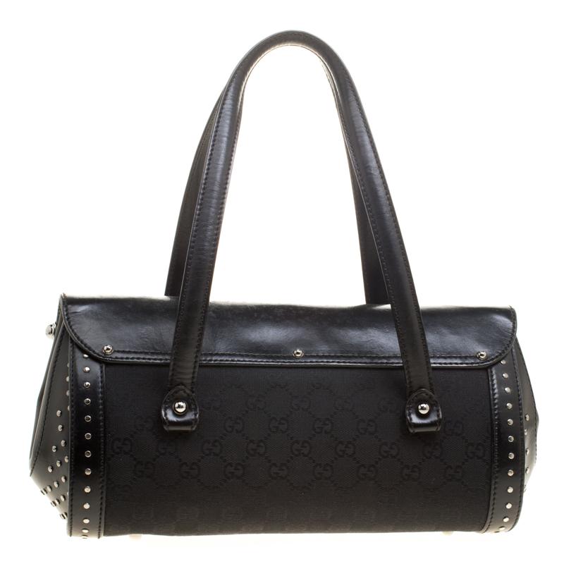 Quench your desire for the perfect satchel with this fabulous Gucci piece. This bag is crafted from black GG canvas as well as leather, and it features two handles and a fabric lined interior which is spacious enough to carry your everyday