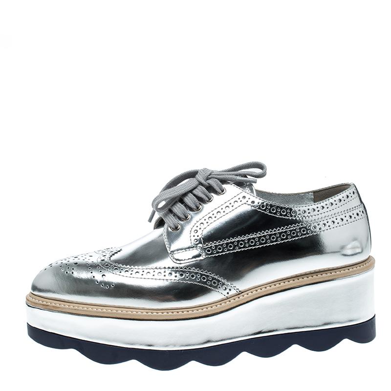 Flaunt your love for all things glamorous at the highest level with these unique and gorgeous shoes by Prada. The shiny metallic silver body is a surefire way to grab attention from all around you as soon as you walk out in them. The shoes carry a