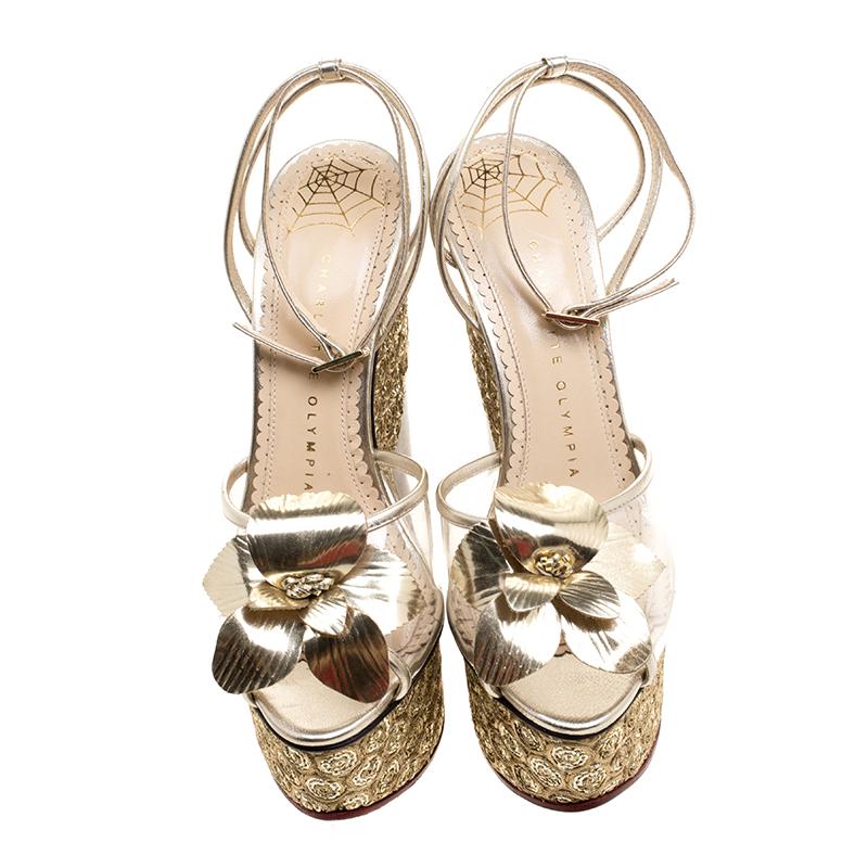 These sandals from the house of Charlotte Olympia are adorned with a chic embellishments that impart a look of effortless grace to the silhouette. Crafted from glowing gold leather and featuring smart ankle straps for easy fastening these platform