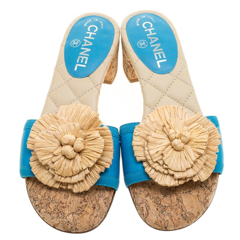 Stay comfortable and effortlessly luxurious and stylish while you step out in the summers wearing this beautiful Chanel Camellia slides. Constructed in blue leather front strap with beige quilted leather insole, these slides feature a large Camellia
