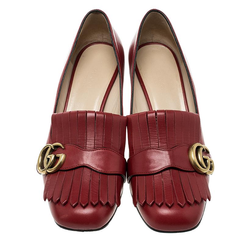 Absolutely on-trend and easy to flaunt, this pair of pumps by Gucci is a true stunner. They've been crafted from red leather and styled with folded fringes and the brand's signature GG on the uppers. Square toes and a set of block heels complete the