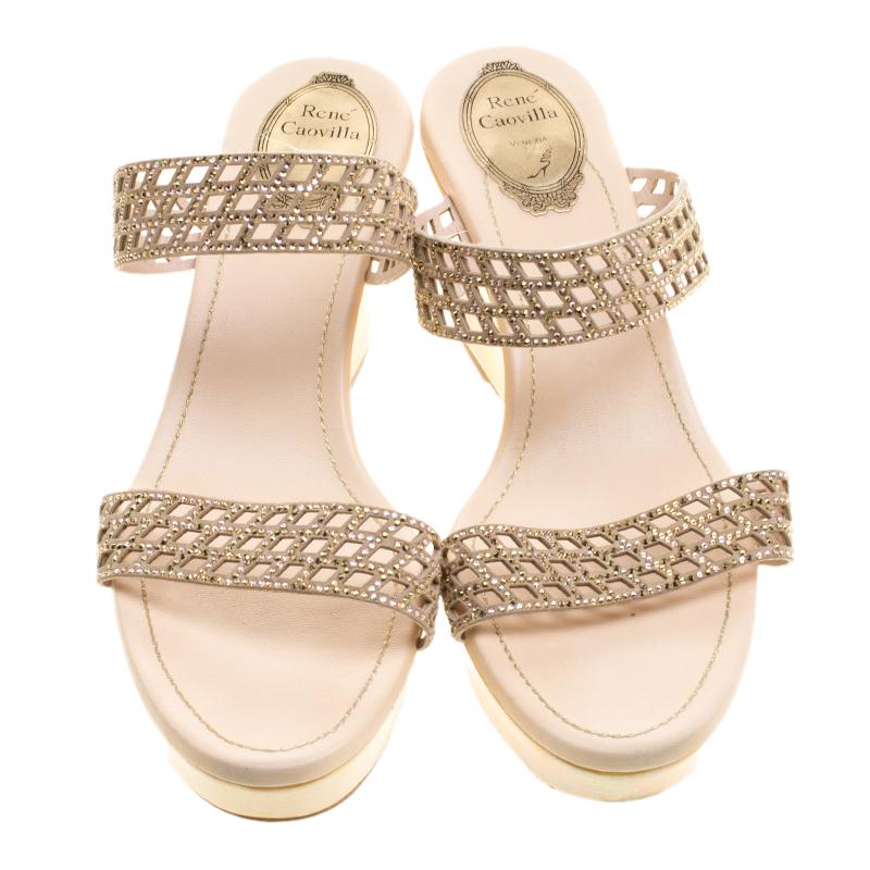 One look at this pair of René Caovilla slides, and our hearts skip a beat. Breathtakingly crafted from leather, they feature laser cuts, embellished straps and an easy-to-strut pair of wedges. The insoles are leather-lined and carry the brand's