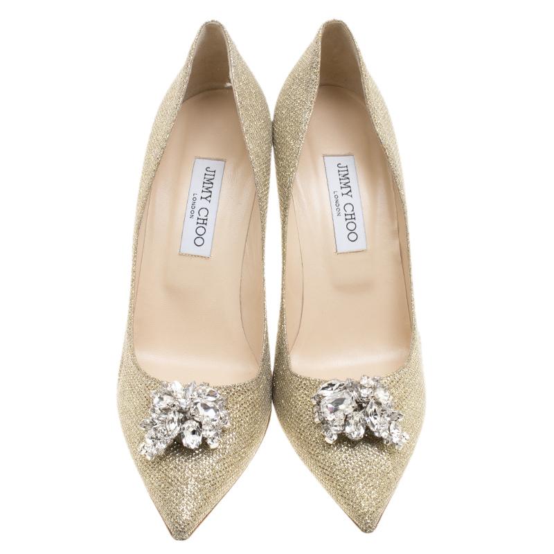 This pair of pumps by Jimmy Choo is a classic. These pumps are lined with leather and create a snug fit. This pair of impressive metallic pumps is made from Lame Glitter Fabric and designed with crystals on the pointed toes and 10 cm