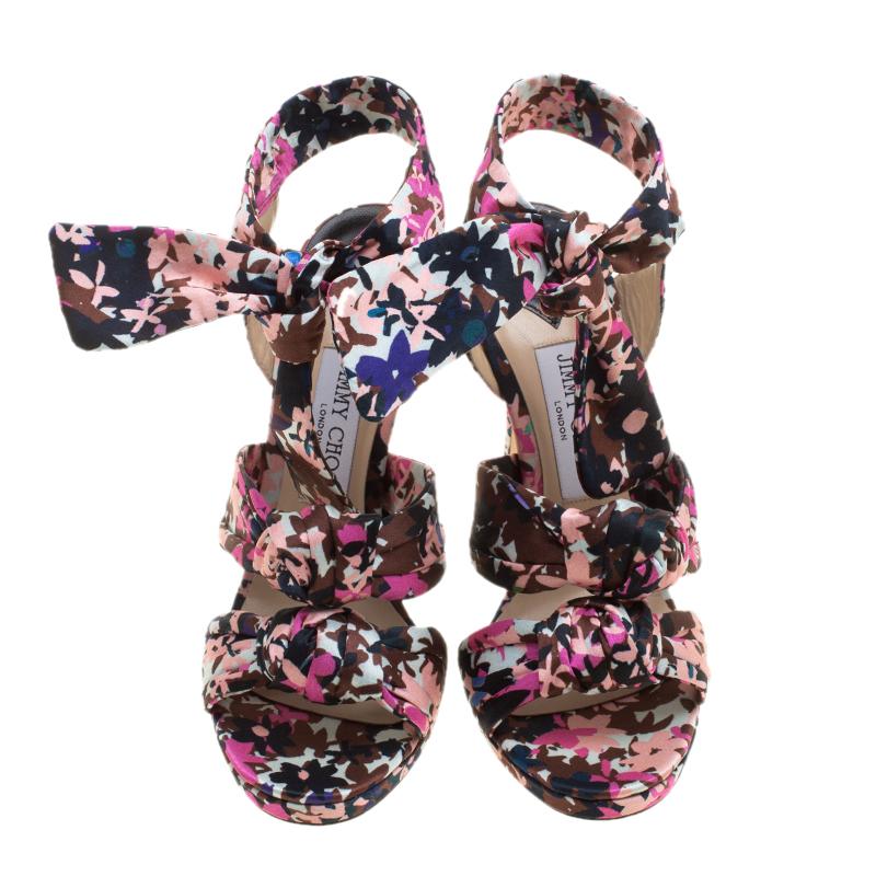 Sing the tune of the season with this gorgeous pair of sandals from Jimmy Choo. They are bursting with fresh floral prints and the satin straps in knots add a modern touch. Platforms, ankle ties, and slim 13 cm heels make the sandals ready to be