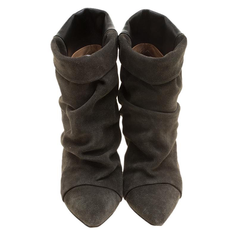 These grey ankle boots from Isabel Marant bring an edgy style. Made from suede and leather, they feature pointed toes with ruched detailing on the front, pointed toes and 10 cm heels.

Includes: Original Dustbag

