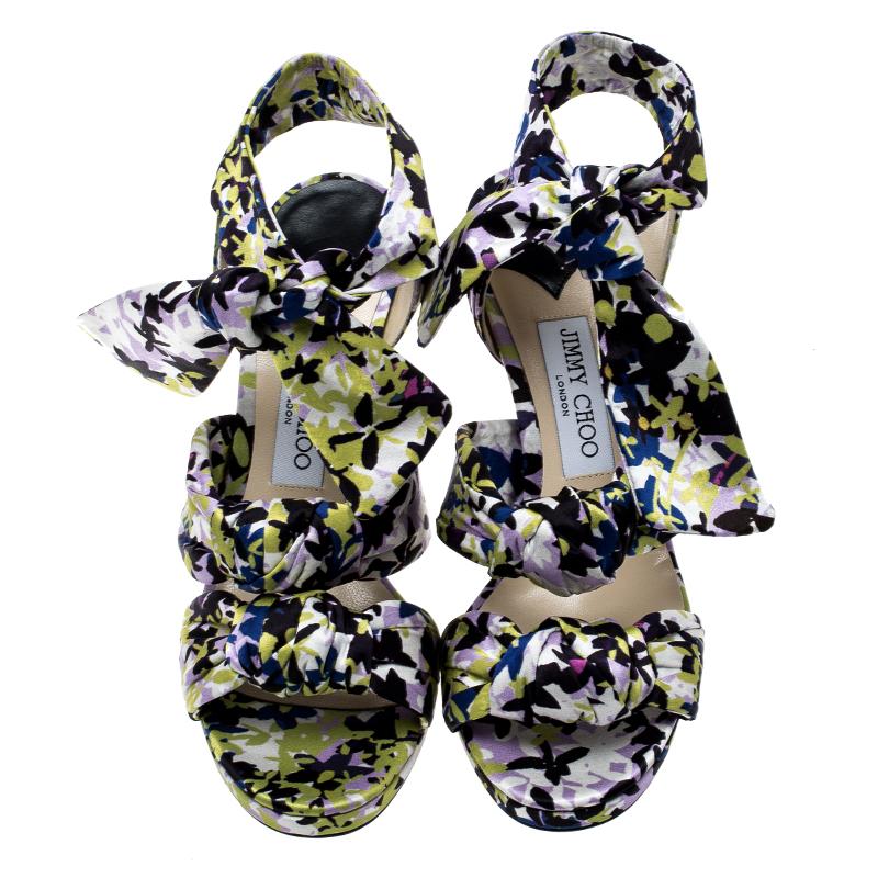 Sing the tune of the season with this gorgeous pair of sandals from Jimmy Choo. They are bursting with fresh floral prints and the satin straps in knots add a modern touch. Thin platforms, ankle ties, and slim 11 cm heels make the sandals ready to