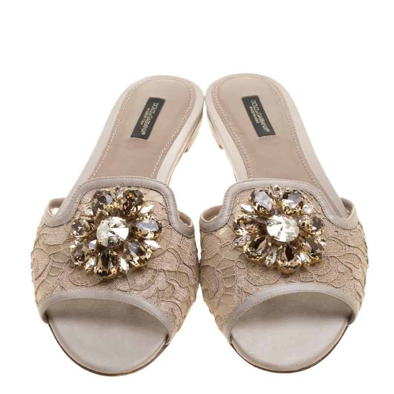 Coming from the house of Dolce and Gabbana, these slides from Dolce and Gabbana feature a lace and mesh frontal strap and completed with leather trims. It comes with a heavy crystal embellished top that makes it perfect for those evening