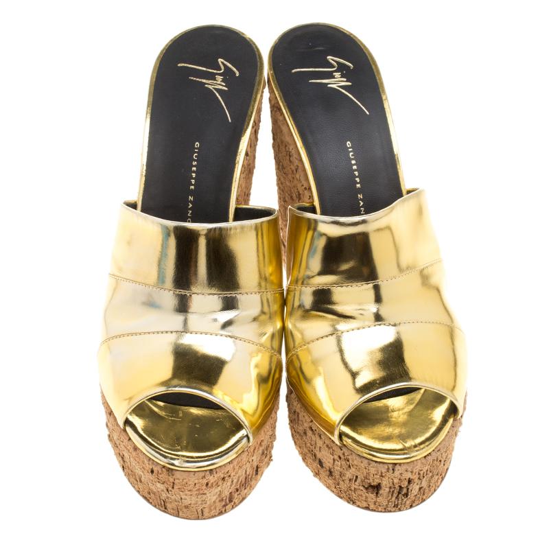 These lovely Giuseppe Zanotti wedge slides will bring you the right amount of style and comfort. They feature a leather strap in metallic gold across the vamps and 13 cm cork wedges. They are pretty and easy to flaunt.

Includes: The Luxury Closet