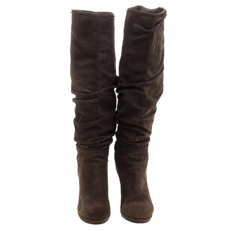 Creations as fashionable as this pair of knee high boots from Prada deserves to be in every woman's closet. They've been created from pleated suede and designed in a slip-on style with round toes and 10 cm wedge heels.

Includes: The Luxury Closet