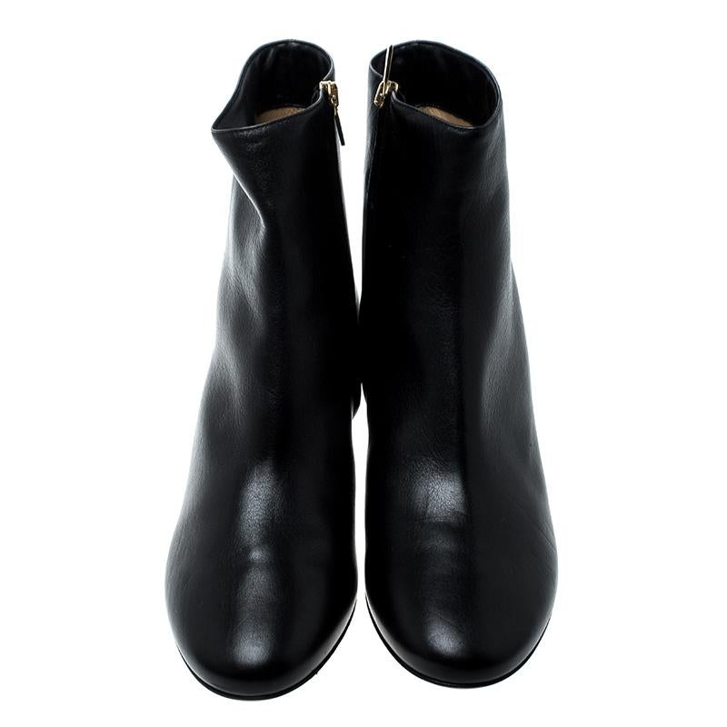 Any lover of luxury will agree that Ferragamo's designs are not only high on style but also comes from excellent workmanship, just like these black ankle boots. Covered in leather and shaped wonderfully, these simple ankle boots have round toes,