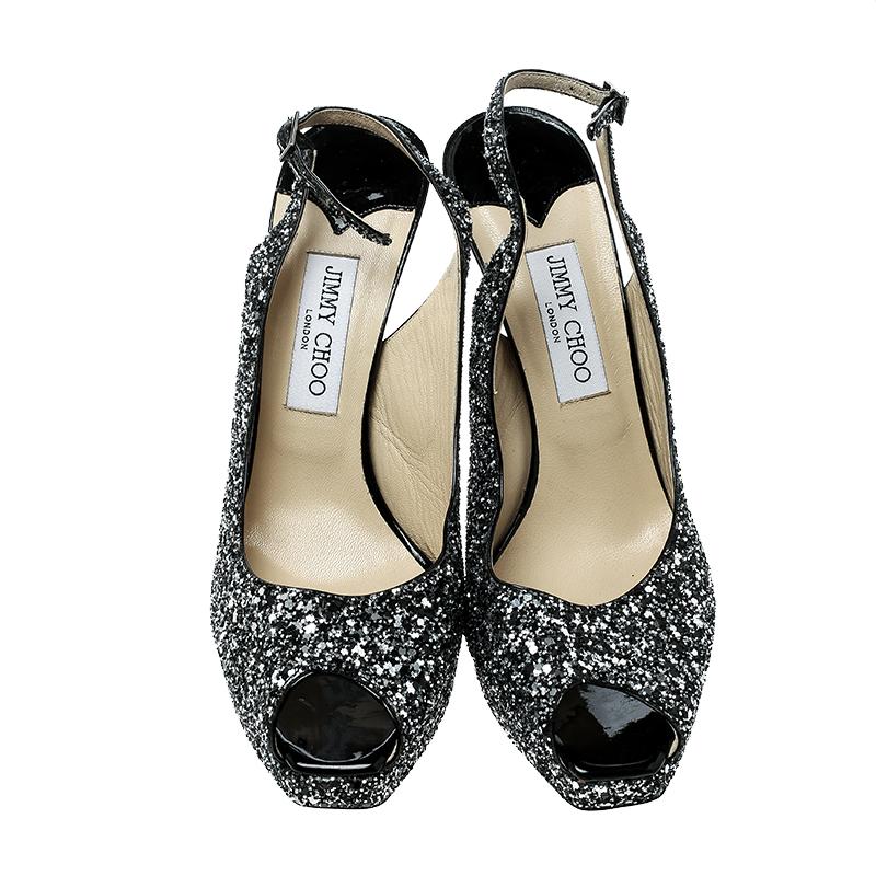 You'll be all set to shine with style in these dazzling Jimmy Choo sandals. They are covered in coarse glitter and designed with peep toes, buckle-held slingbacks, platforms, and 12.5 cm heels. These sandals are sure to attract admirers!

