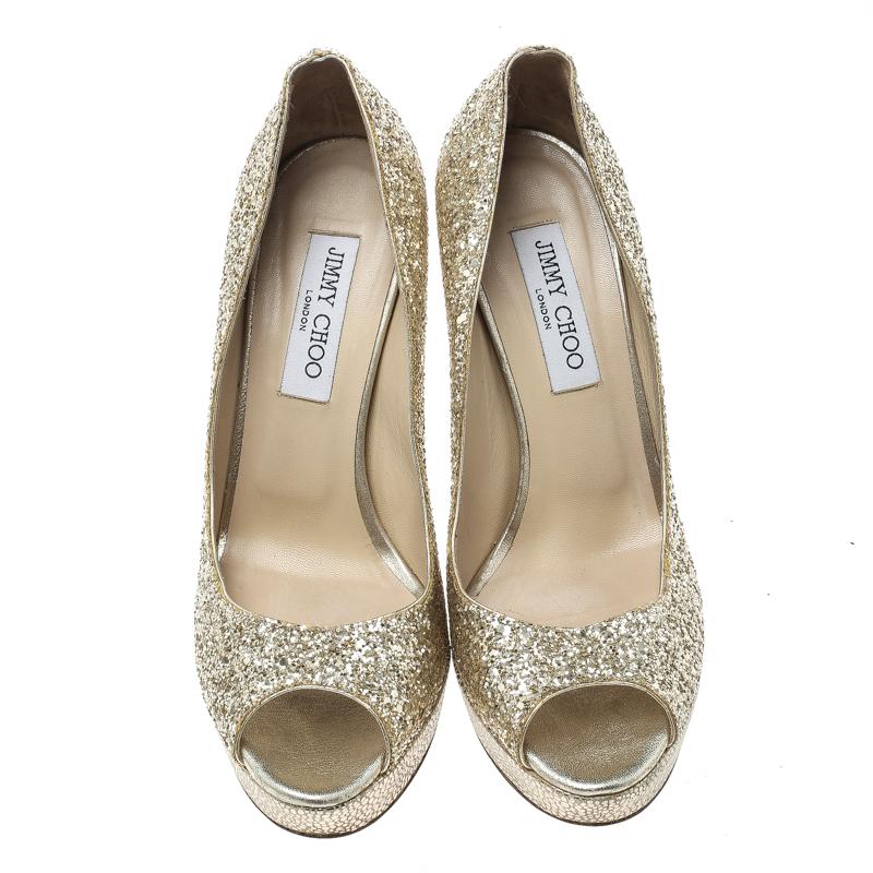 This pair of pumps by Jimmy Choo will leave you looking like a diva. They are covered in coarse glitter and designed with peep toes and 13 cm heels. Add some style to your closet by slipping into this pair of metallic gold pumps.

