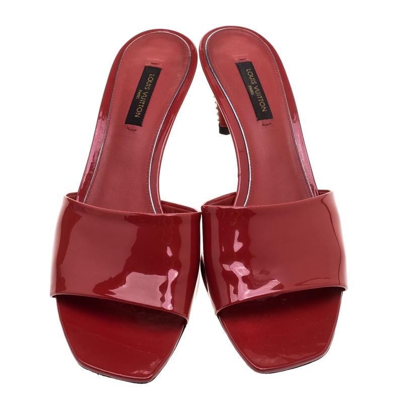 These slides from Louis Vuitton have come straight from a shoe lover's dream. Designed with patent leather in red and crystals on the 6.5 cm heels, the slides can be worn with any chic outfit of your choice.

Includes: Original Box, Original