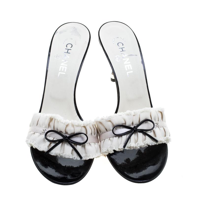 These slides from Chanel are trendy and easy to slip on. They are designed with bows and CC logos on the pleated straps and elevated on 9 cm heels. This is one pair that speaks elegant fashion in a simple way.

