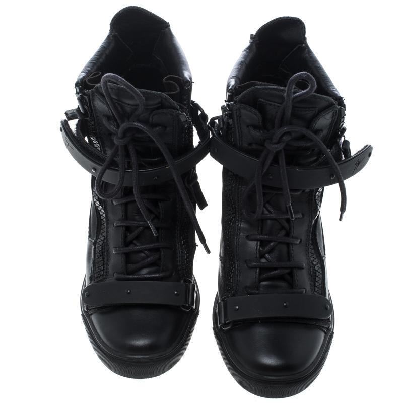 Create a unique style statement with your casual looks wearing this Giuseppe Zanotti Lorenz wedge sneakers. Designed in black leather, these ankle top sneakers feature a lace-up detail at the front along with straps and zipper accent creating a chic