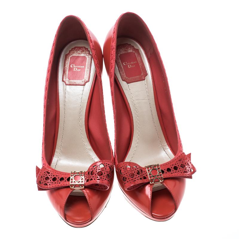 Adorn your feet with this adorable pair of platform pumps by Dior. Boasting a coral leather exterior, they feature an interestingly styled topline and cute bows on the vamps. The insoles are leather-lined and carry brand detailing. Complete with