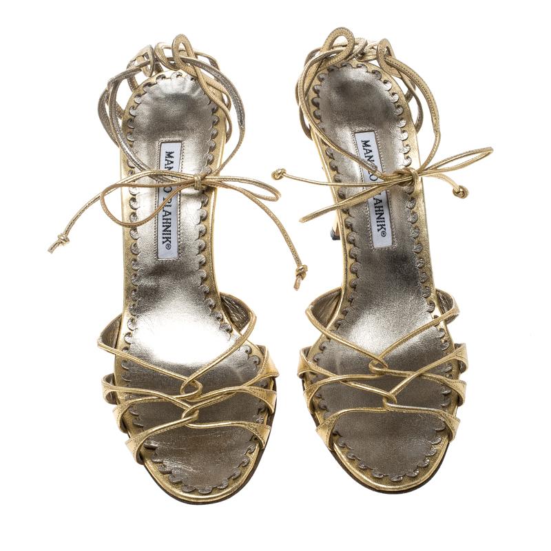 Chic, sophisticated and very stylish, these strappy sandals from Manolo Blahnik are perfect to adorn your feet. The metallic gold sandals are crafted from leather and feature an elegant silhouette. They flaunt a 9.5 cm heel, an open toe ankle wrap