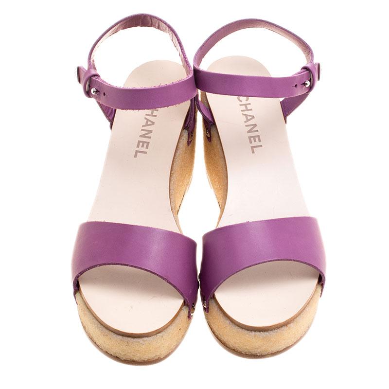 The perfect pair for summer, these lovely Chanel sandals give out chic vibes. Their chunky cork wedges are coupled with supporting platforms, and their bright purple exterior features a single front strap, ankle straps with hook closure, open toes