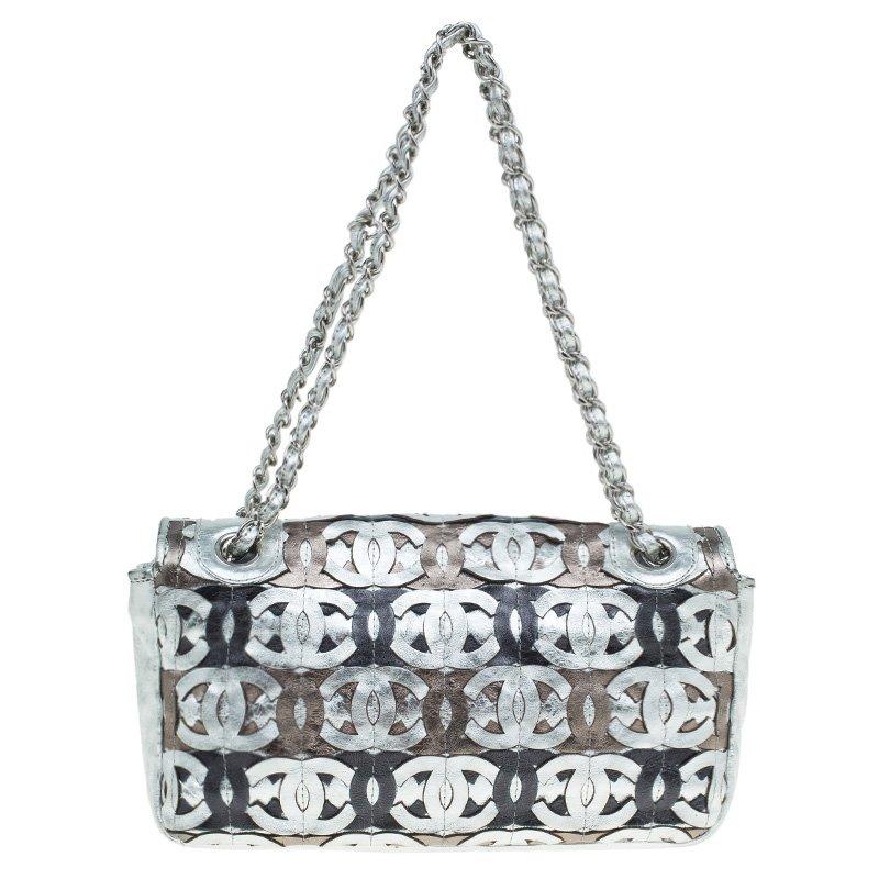 Crafted from silver metallic leather, this flap bag comes from the house of Chanel. The exterior is designed with interlocking CC cut out adornments throughout in Silver / Bronze / Black leather. It comes with signature chain-leather strap and a CC
