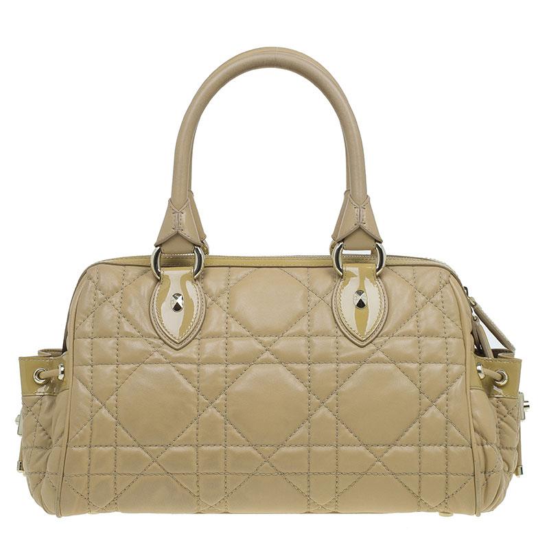 In true Dior style, this satchel is functional as well as stylish. Made from Cannage quilted leather, the exterior features double rolled handles and side pockets with drawstrings. Secured with a top zip closure, the nylon lined interior features a