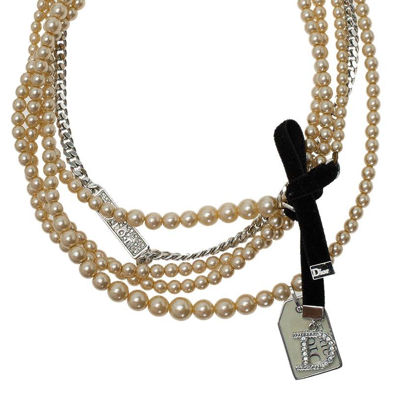 Accentuate your feminine charm with this Dior necklace and cast a magical spell. This silver plated chain and faux pearl necklace is accented with multiple strands, Dior charm and tags, and a bow detail.

Includes: The Luxury Closet Packaging

