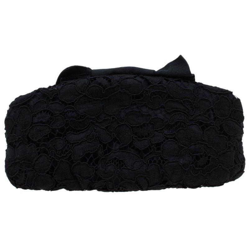 This luxurious and opulent Evening bag from Dolce and Gabbana will give your look a stylish finish. Crafted from fabric, it features an adorable lace pattern and is adorned with an impressive bow. The gorgeous black satin lined interior carries an