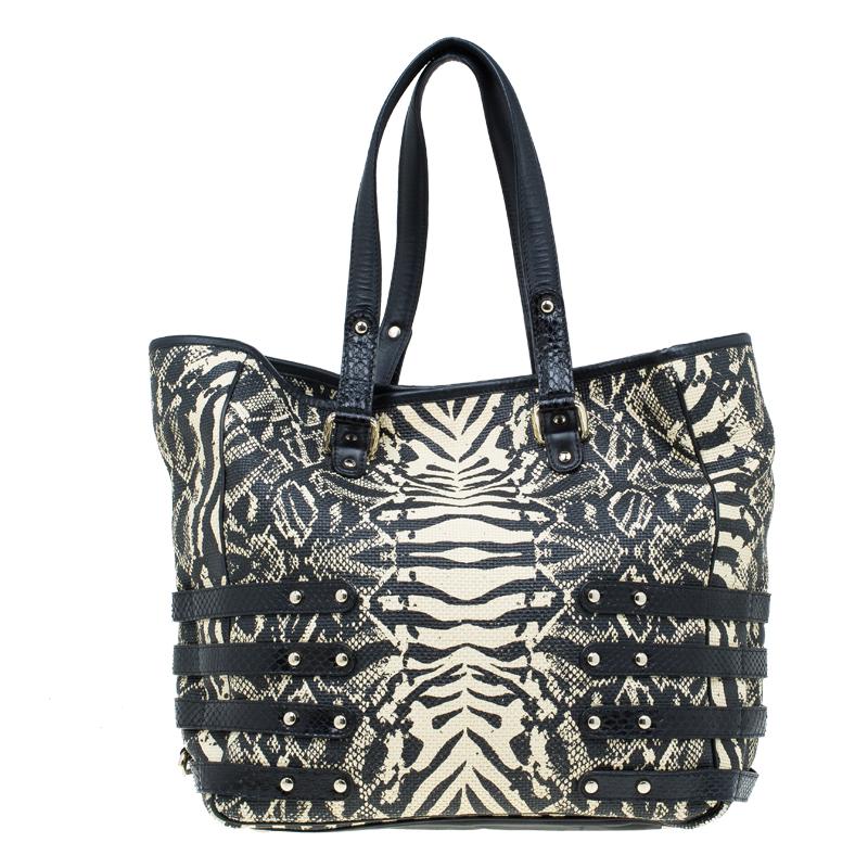 Jimmy Choo is all set to impress you with its new collection of Babeth shopper tote, that a lady will never fail to flaunt. Crafted from printed raffia, it is adorned with attractive belted straps and features two top handles. This tote is