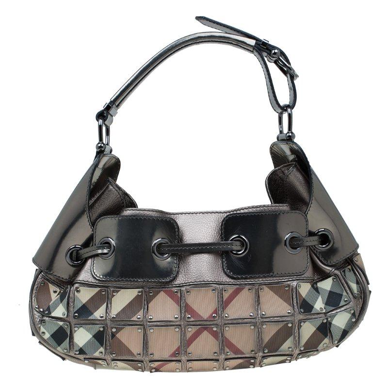 Coming from the house of Burberry, this Warrior hobo is an iconic bag. Crafted from leather, it features individual square panels of their iconic check print. The exterior also features a drawstring closure and buckle-detailed adjustable shoulder