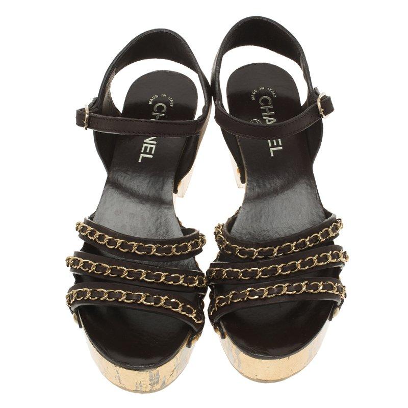 Add this bold and striking pair of platform sandals by Chanel to counter an eye catching look. Crafted with leather, they feature impressive vamps with chain adornments and have studded detailing. This pair is accentuated with ankle straps