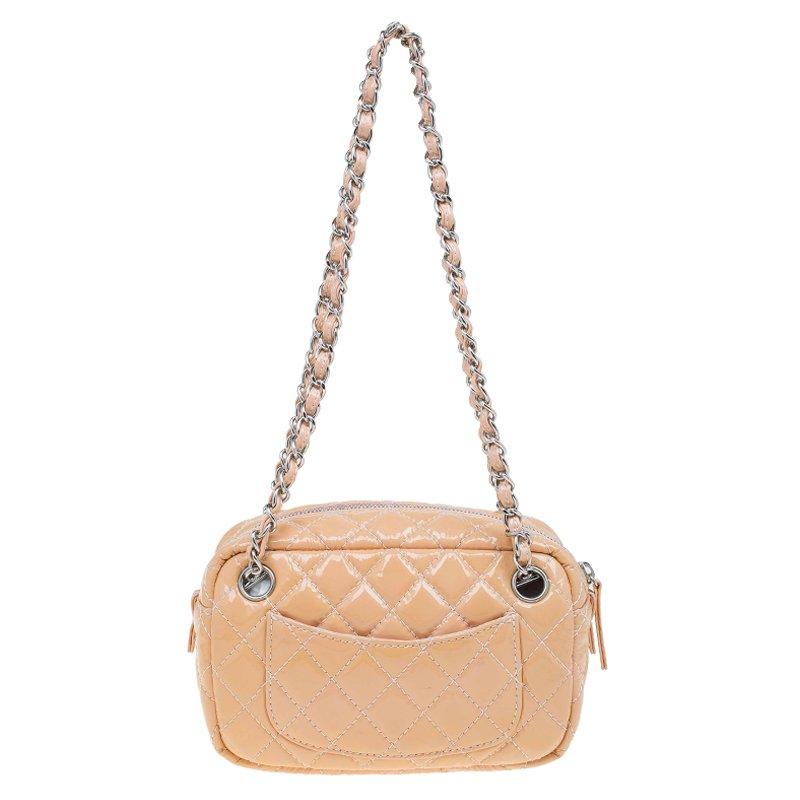 From the iconic Valentine collection recognized by the heart-shaped CC logos, comes this well-known camera bag by Chanel. Crafted from glossy beige patent leather the gorgeous quilted exterior is accented with silver-tone hardware. It comes with