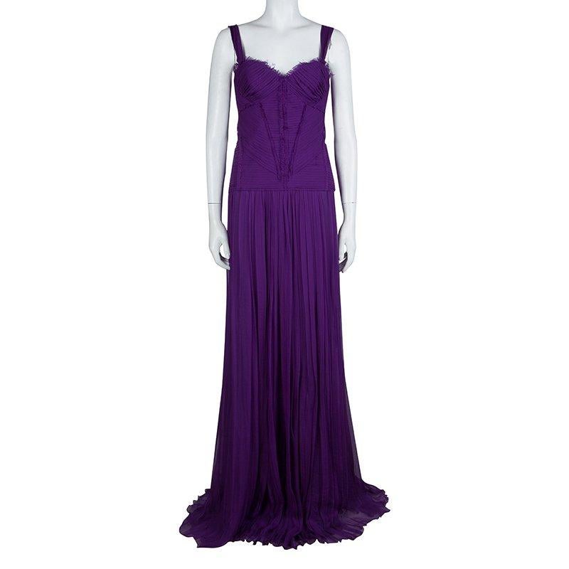 With signature pleating and pintuck details, this gown comes from the house of Alberta Ferretti. This sleeveless gown has been crafted in a deep purple silk and has been shaped with a sweetheart neckline. Strappy shoulders, fitted bodice, and