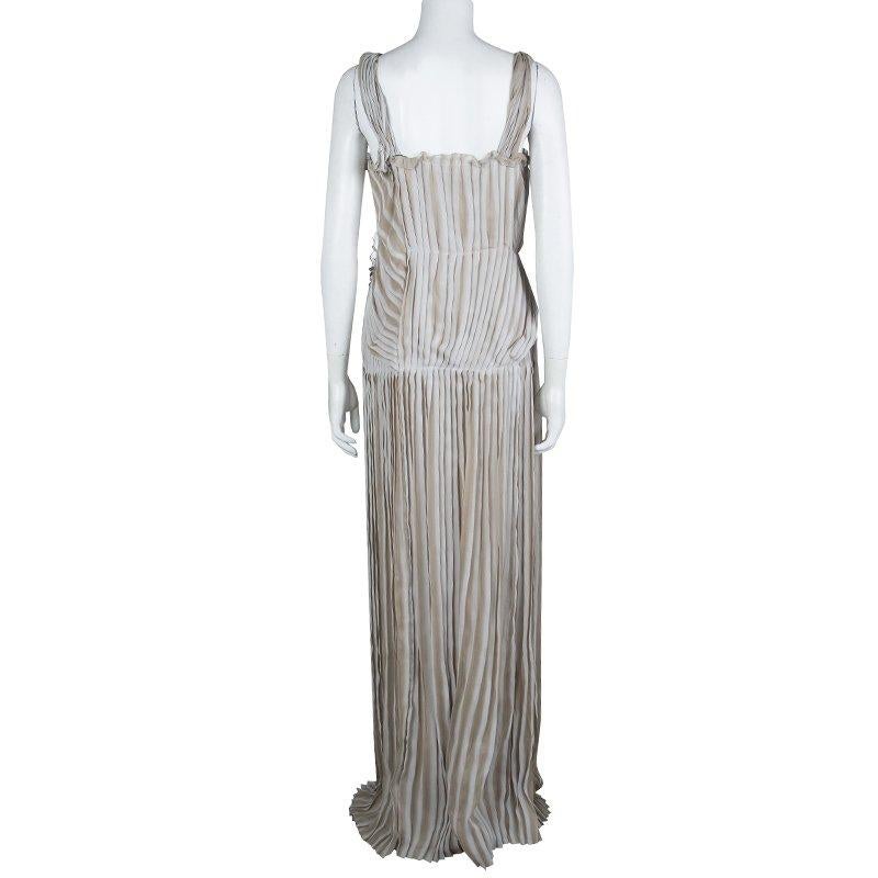 Best known for designs featuring twisting, tucking, and draping techniques, this gown comes from the house of Alberta Ferretti. This gown is crafted in beige silk with pleated pintuck details. Style it with bold modern jewelry on dainty pieces for