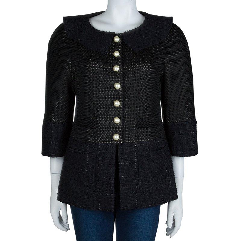 This jacket by Chanel is crafted with multiple fabrics this jacket displays a blend of textures. It is styled with four front pockets, round collars, and bracelet length sleeves. The jacket is accented with white faux pearl buttons.

Includes: The