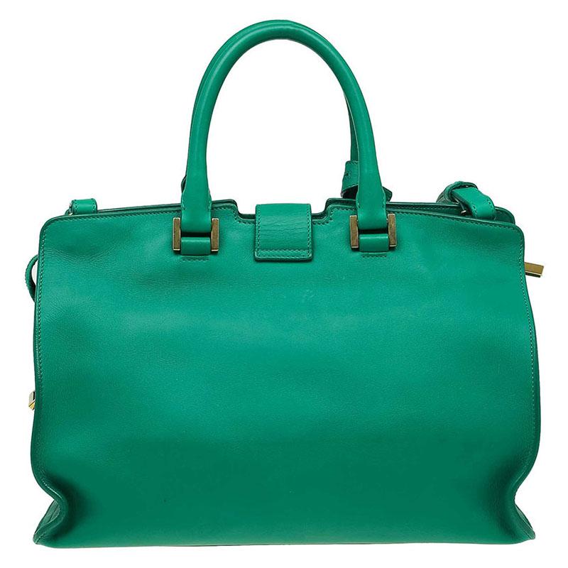 Saint Laurent’s small Cabas tote is impeccably structured in smooth, green leather. Its interior boasts of a spacious compartment with slip pockets while its exterior is neatly stamped with a gold-tone 