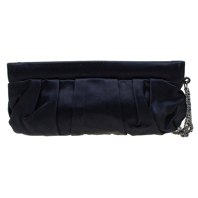 A satin wristlet clutch, this Gucci piece has a gathered detail and a silver tone chain that can be used to carry it. It has a slip pocket within the main compartment to keep belongings separately. The highlight of the piece is the circular