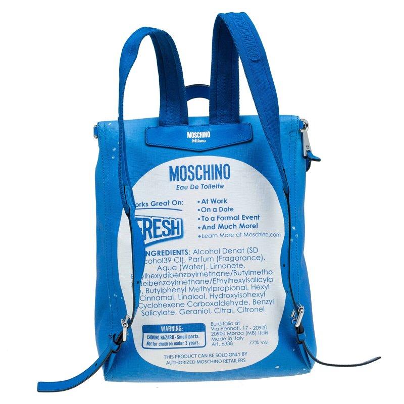 From Moschino Fresh Couture Spring '16, this blue backpack with 'Moschino Eau de Toilette' slogan is designed under the creative direction of Jeremy Scott. Secured by the two-way zipper, it is crafted from faux textured-leather and proportioned to