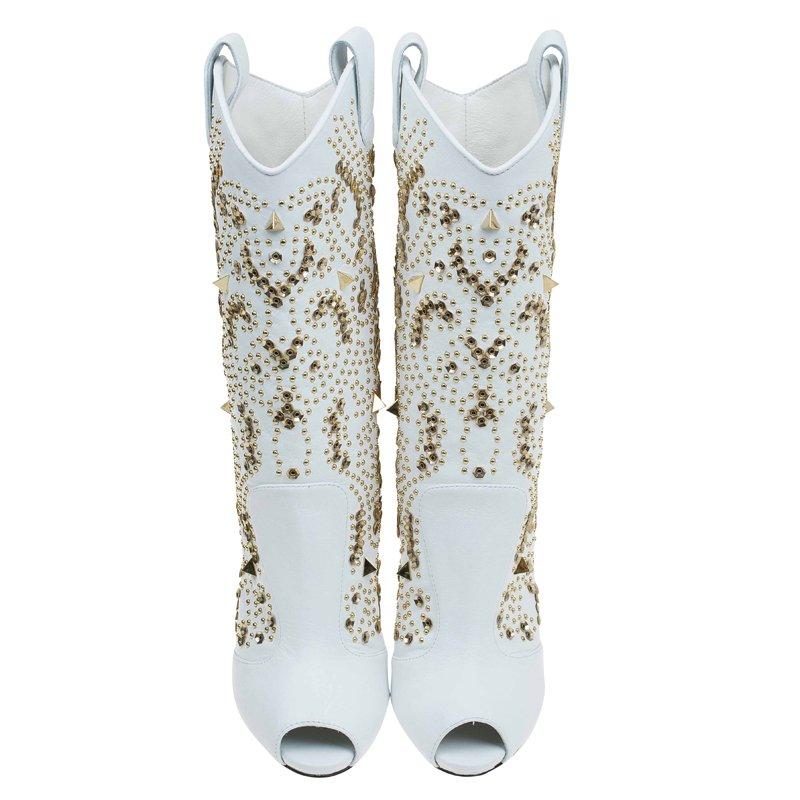 Your inner cowgirl is going to be delighted by this Giuseppe Zanotti creation. It has been crafted from 100 percent genuine leather that is snowy white in color. Gorgeously studded with gold studs, these midcalf boots have peep toes and are perfect