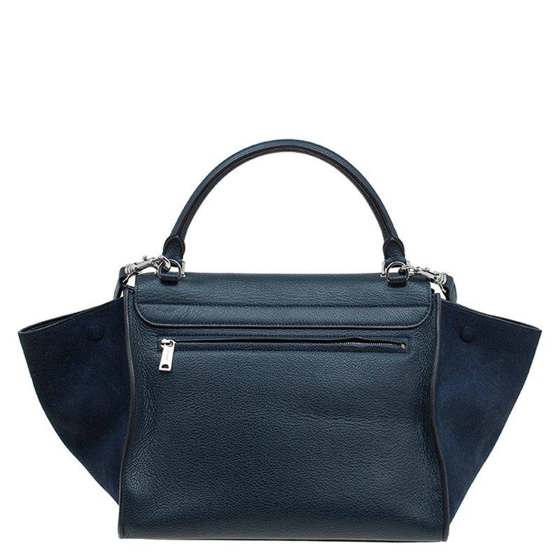 The instantly recognisable 'Trapeze' bag from Celine is a gorgeous addition to your wardrobe. This medium Trapeze bag is crafted from leather and suede in a navy blue shade. The iconic wing style in luggage-tote, a rolled up top handle and a
